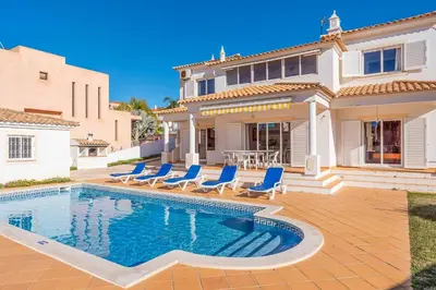 a villa with a swimming pool in front of a house at Villa Sofy in Galé