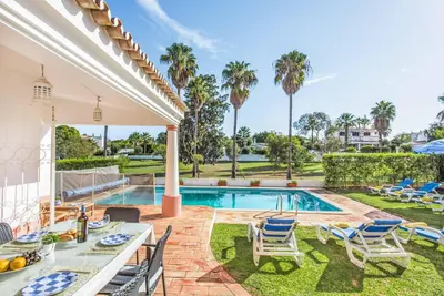 a patio with a table and chairs and a swimming pool at Casa Lorena in Guia
