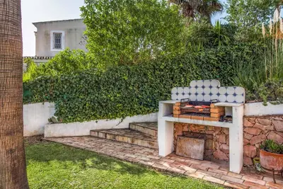 a bench sitting next to a stone wall at Casa Lorena in Guia