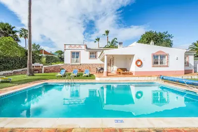 a swimming pool in front of a house at Casa Lorena in Guia