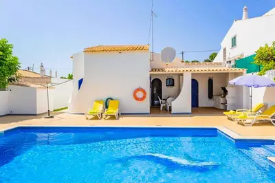 a swimming pool in front of a house at Villa Marco in Galé