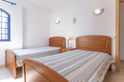 a bedroom with two beds and a window at Villa Marco in Galé