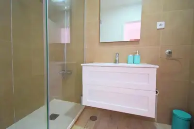a bathroom with a sink and a glass shower at 3 min walking to the beach & Old Town by Algarve Dream Holidays in Albufeira