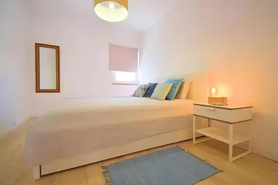 a bedroom with a bed and a table with a mirror at 3 min walking to the beach & Old Town by Algarve Dream Holidays in Albufeira