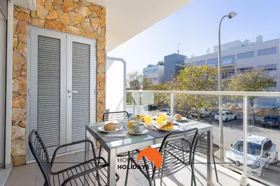 a balcony with a table with food on it at #200 Panoramic Flat by Home Holidays in Albufeira