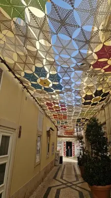 a hallway with a ceiling covered in stained glass at Domek v srdci Fara in Faro