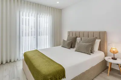 a bedroom with a large bed and a window at Sublime and Bright 2 BDR Apartment by LovelyStay in Quarteira