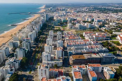 an aerial view of a city and the beach at Sublime and Bright 2 BDR Apartment by LovelyStay in Quarteira