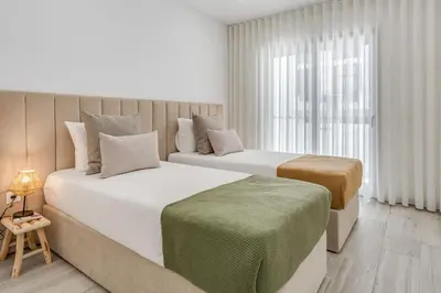 a bedroom with two beds and a window at Sublime and Bright 2 BDR Apartment by LovelyStay in Quarteira