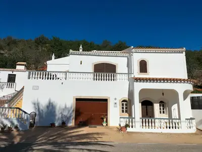 a large white house with a large garage at Vivenda Atanázio By Férias com Sol in Loulé
