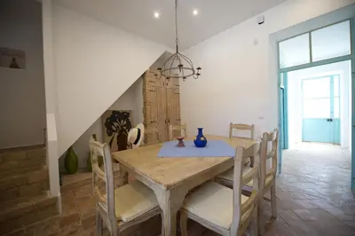 a dining room with a wooden table and chairs at Quinta Amarela XL by Portucasa in Loulé
