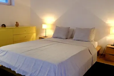a bedroom with a large white bed with two pillows at Quinta Amarela XL by Portucasa in Loulé