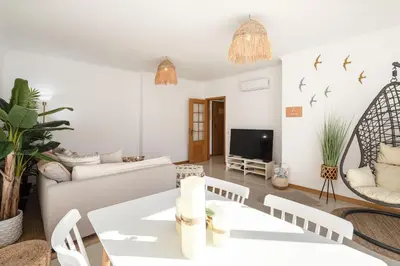a living room with a couch and a table at Modern 1BR Apartment in Central Albufeira with Balcony & Parking, by Hopstays in Albufeira