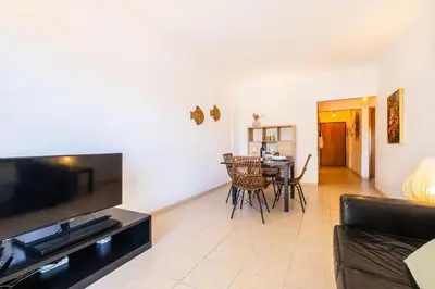 a living room with a couch and a table at Solymar Apartment in Guia