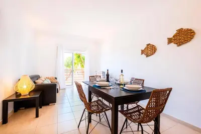 a dining room with a black table and chairs at Solymar Apartment in Guia