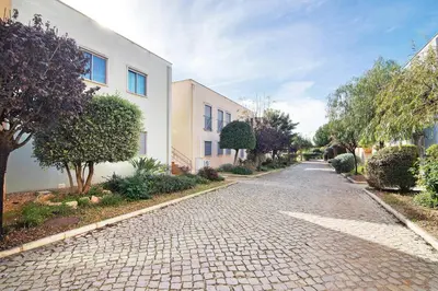 a cobblestone street in front of a building at Condomínio Quinta do Vale in Guia