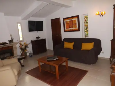 a living room with a couch and a coffee table at Casa Pinheiromar in Albufeira