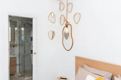 a room with a bed and a mirror on the wall at Gyula Old Town Apartment in Albufeira