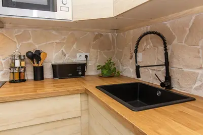 a kitchen with a sink and a counter top at Gyula Old Town Apartment in Albufeira