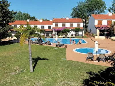 a view of a swimming pool in a resort at V2 Vilar Jardim Piscina wifi in Quarteira