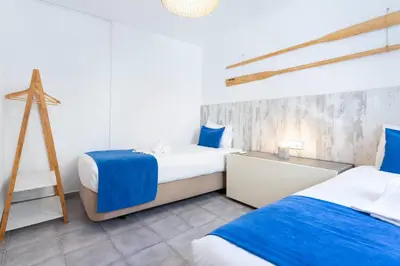 two beds in a room with blue and white at #197 Casa Gili by Home Holidays in Albufeira