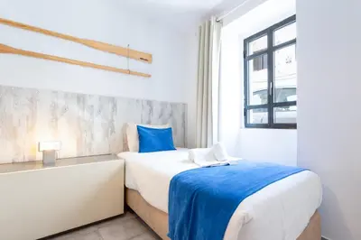 a bedroom with a large bed and a window at #197 Casa Gili by Home Holidays in Albufeira