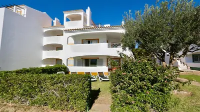 a large white building with bushes in front of it at Green Valley 05, Cleverdetails, Sleeps 6 adults and 2 children, 4 salted water pools in Vilamoura