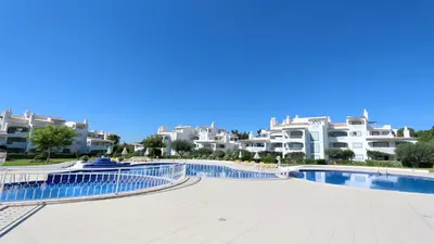 a swimming pool in front of some apartment buildings at Green Valley 05, Cleverdetails, Sleeps 6 adults and 2 children, 4 salted water pools in Vilamoura