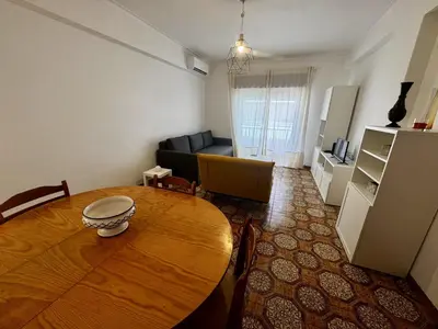 a living room with a couch and a table at XperienceHouse Algarve in Quarteira