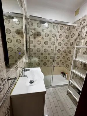 a bathroom with a sink and a mirror at XperienceHouse Algarve in Quarteira