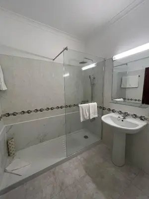 a bathroom with a shower and a sink and a toilet at STUDIO COMPLETO PARA 2 PESSOAS in Albufeira