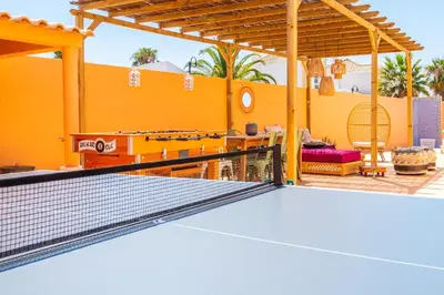 a tennis court with a ping pong racket at Villa alhabu in Albufeira