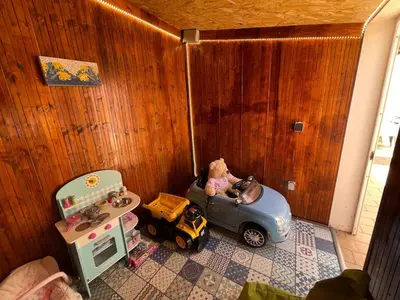 a childs play room with a toy car and a sink at Villa alhabu in Albufeira