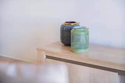 two vases sitting on top of a wooden table at Notre Damme Apartment in Albufeira