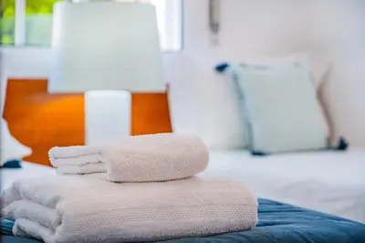 a stack of towels sitting on top of a table at Notre Damme Apartment in Albufeira