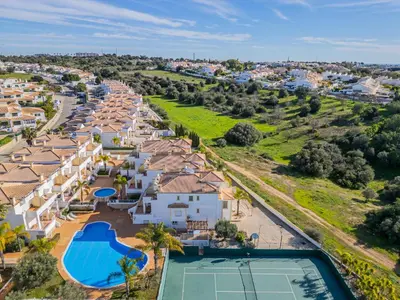 an aerial view of a resort with a tennis court at Villa Adriana in Albufeira