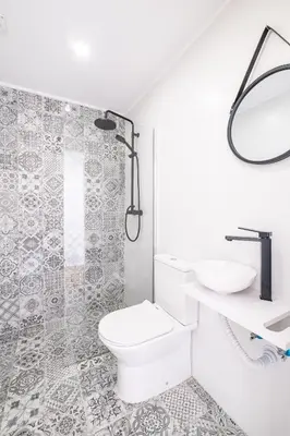 a white bathroom with a toilet and a sink at SERAFIM BEACH APARTMENT - Heart of the Old Town in Albufeira