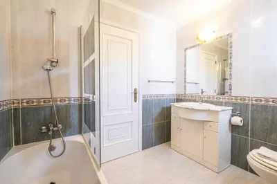 a bathroom with a tub and a sink and a toilet at Apartamento Casa Vela in Albufeira