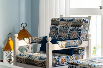 a blue and white room with a chair and a window at Villa Melissa in Albufeira