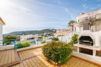 a house with a pizza oven on a balcony at Villa Melissa in Albufeira