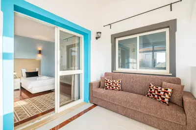 a living room with a couch and a view of a bedroom at Villa Melissa in Albufeira