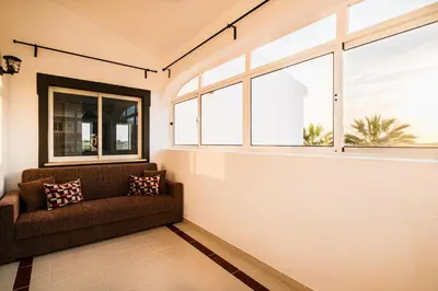 a living room with a couch and windows at Villa Melissa in Albufeira