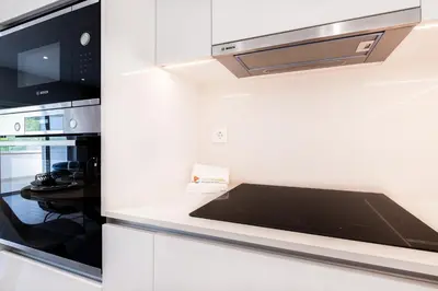 a kitchen with a stove and a microwave at Guerreiros Lovely Stay in Albufeira
