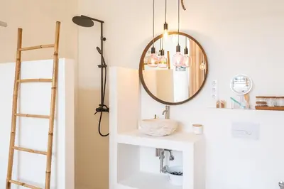 a bathroom with a mirror and a sink at Anabella Guest House in Albufeira