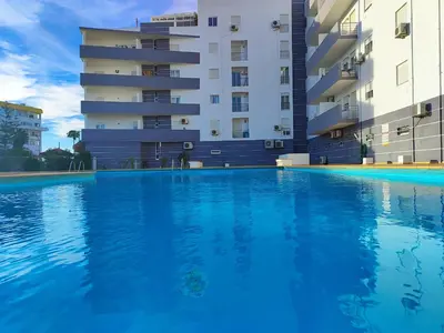 an empty swimming pool in front of a building at Albufeira Vintage Apartment 1 With Pool by Homing in Albufeira