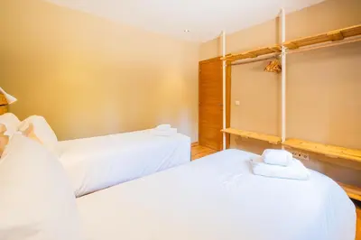two beds in a room with white sheets at Casa Picota in Boliqueime
