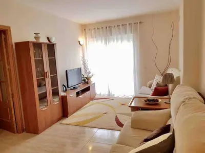 a living room with a couch and a tv at Charming 3 bed apartment @ Al-Sakia Village in Quarteira