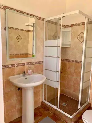 a bathroom with a sink and a shower at Charming 5 bed Private Villa - Quarteira in Quarteira