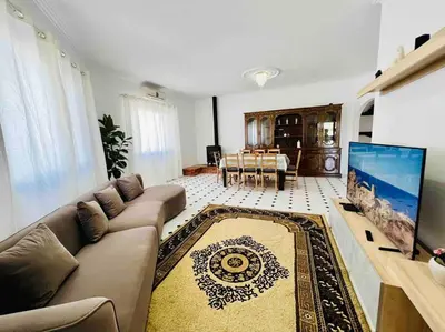 a living room with a couch and a flat screen tv at Charming 5 bed Private Villa - Quarteira in Quarteira