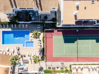 an overhead view of a building with a tennis court at Apartment Arrifes in Albufeira